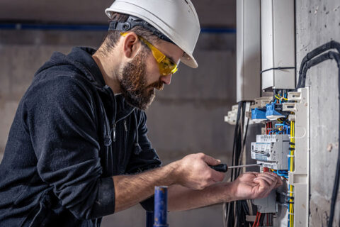 man repairing electrical equipment