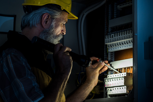 An Electrician Repairing an Electric Panel in Emergency in Long Island, NY