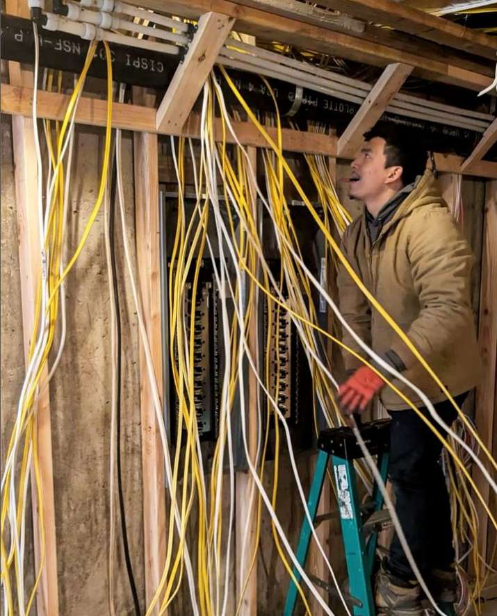 Technician performing an electrical panel upgrade in Long Island, NY, with advanced tools