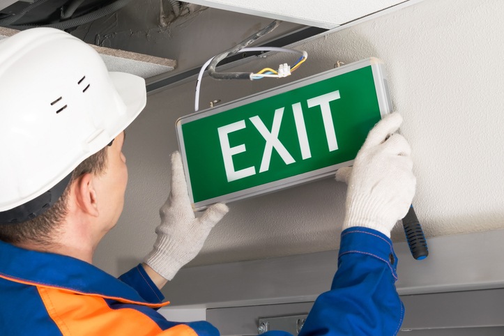 Electrician Installing an Exit Sign Light in Long Island, NY